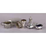 A silver three-piece condiment set with card-cut rims, London 1894; a late Victorian leaf-embossed