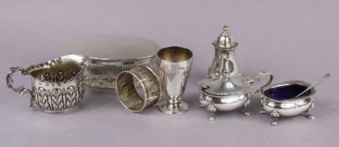 A silver three-piece condiment set with card-cut rims, London 1894; a late Victorian leaf-embossed