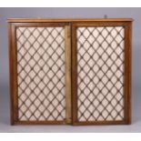 A set of regency mahogany hanging wall shelves enclosed by pair of brass grille doors, 72cm x 62cm