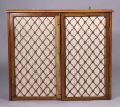 A set of regency mahogany hanging wall shelves enclosed by pair of brass grille doors, 72cm x 62cm