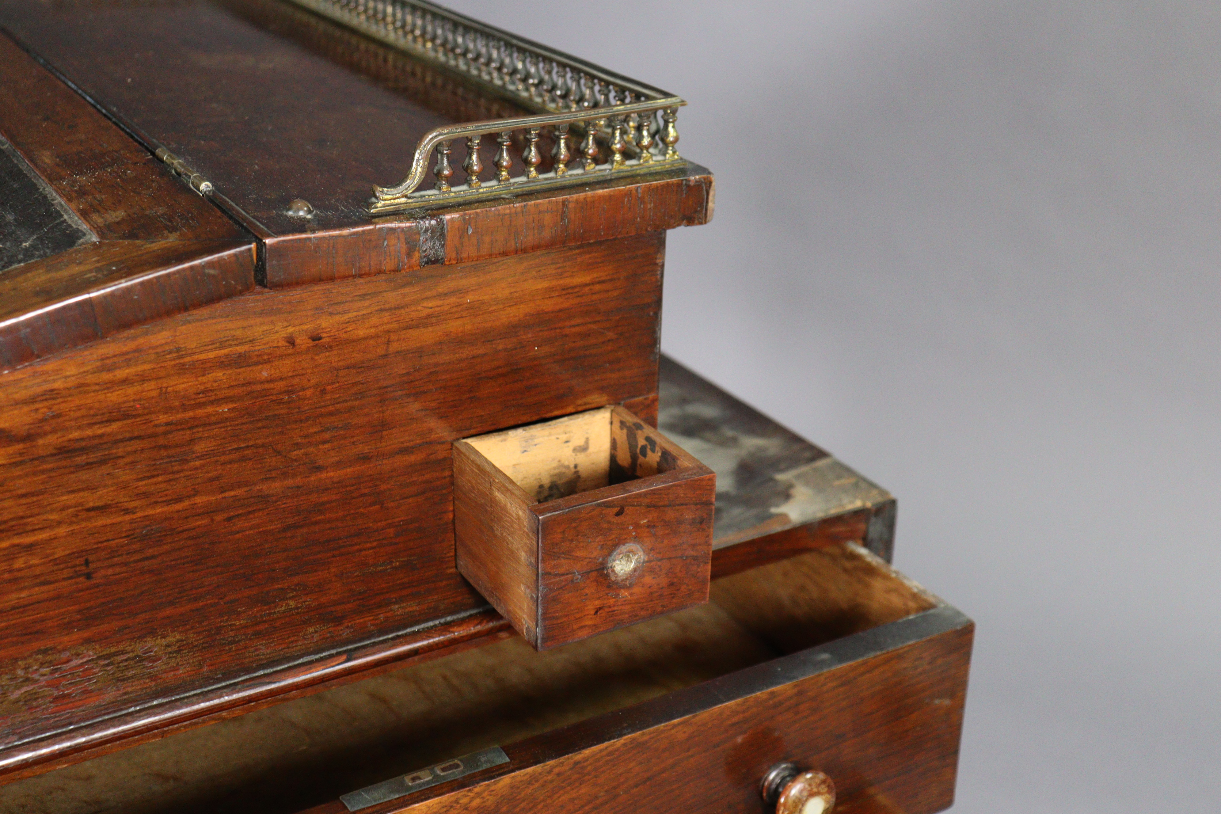 An early 19th century rosewood davenport, the forward-sliding top with brass gallery & long hinged - Image 3 of 9
