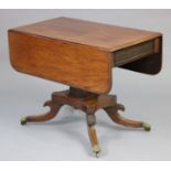 A regency mahogany drop-leaf centre table, fitted with a frieze drawer to one end, on a square