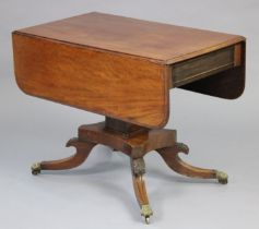 A regency mahogany drop-leaf centre table, fitted with a frieze drawer to one end, on a square