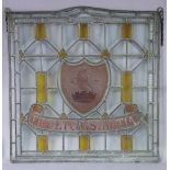 A Victorian stained & leaded glass panel with central armorial crest & motto “Fide Et Constantia” (