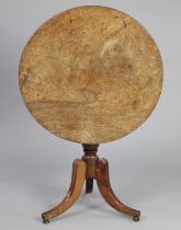 A Georgian mahogany tripod table with a circular tilt-top, on a turned centre column & three splay