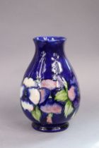 A Moorcroft pottery Pansies pattern baluster vase of deep blue ground, 24cm high, impressed