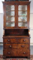 An early 19th century French fruitwood bookcase with three shelves to the upper part enclosed by