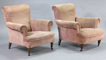 A pair of late 19th/early 20th century upholstered low armchairs, on short turned legs with castors,