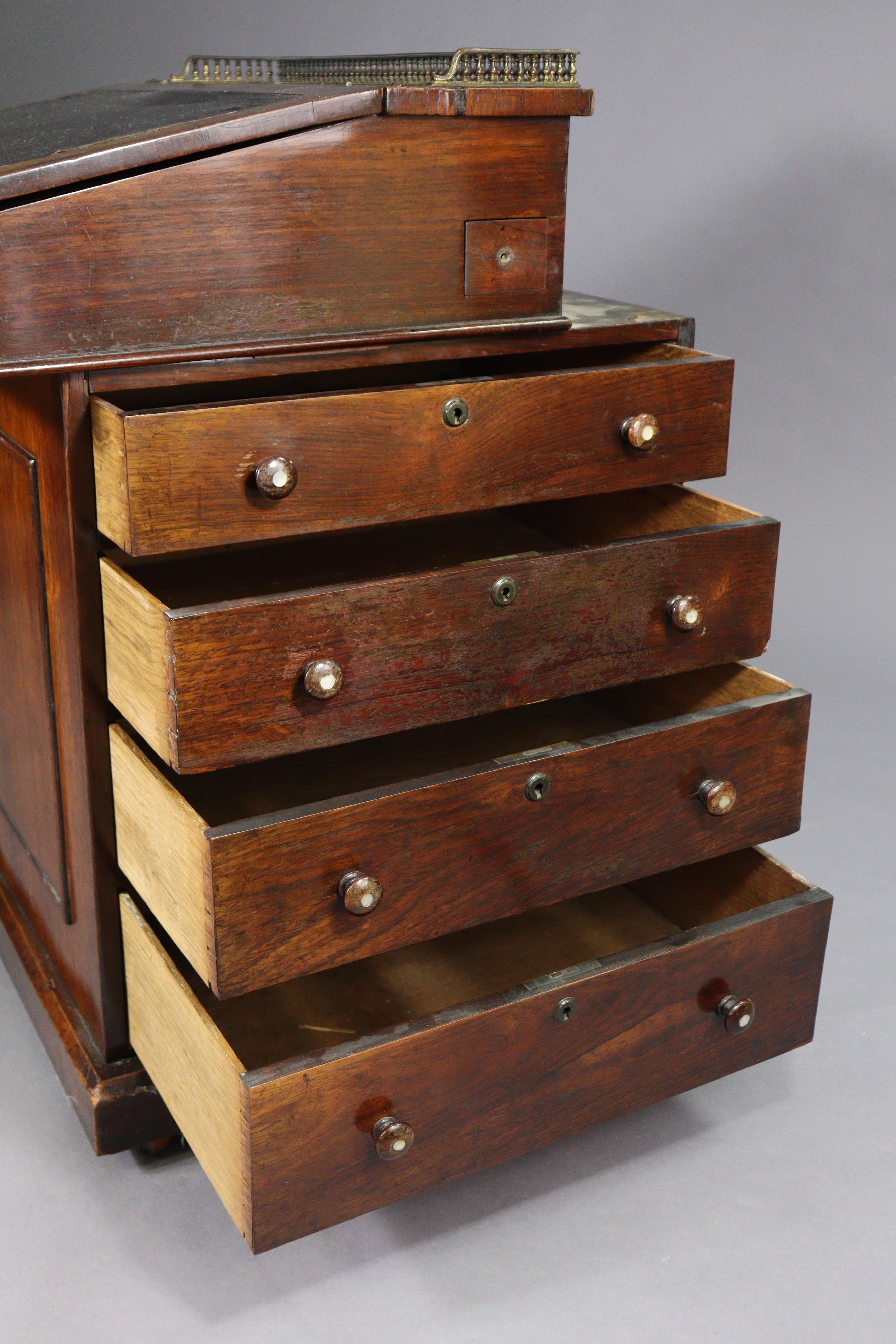 An early 19th century rosewood davenport, the forward-sliding top with brass gallery & long hinged - Image 6 of 9