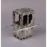 An early 20th century continental silver model of an 18th century sedan chair, decorated with rococo