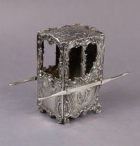 An early 20th century continental silver model of an 18th century sedan chair, decorated with rococo