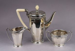 A George V silver three-piece coffee service with panelled sides & rope-twist borders, the coffee