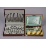 A set of six silver plated dinner knives & forks with bone handles; & in a mahogany case; & a part