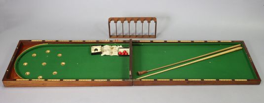 A late 19th/early 20th century mahogany folding table-top bagatelle board (split to top, inset green