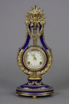 A V&A museum reproduction ‘Marie Antoinette’ mantel clock of Lyre shape, with gilt mounts & Roman