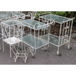 Two white painted wrought-iron tea trolleys; & five ditto occasional tables.