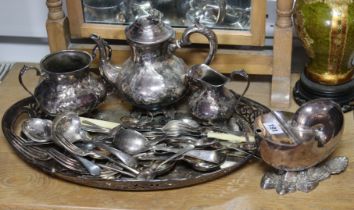 A silver-plated nautilus shell spoon warmer; a plated three-piece tea service; a plated oval tea