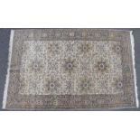 A Persian pattern rug of ivory ground with all-over repeating floral patterns surrounded by multiple