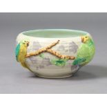 A Clarice Cliff pottery bowl with raised design of budgerigars seated on a branch (No. 845), 21cm