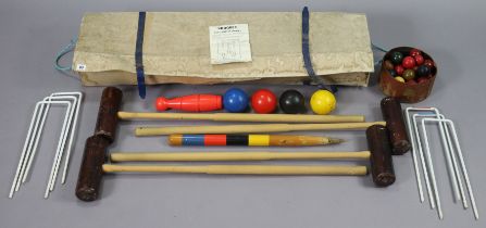 A croquet set, boxed; & a set of snooker balls.