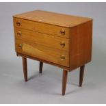 A mid-20th century small teak chest fitted three long graduated drawers, & on short round tapered