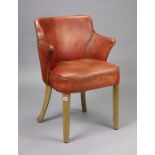 A tan leather tub-shaped office chair on square tapered legs.