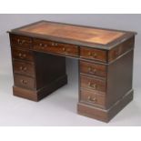 A reproduction mahogany pedestal desk inset gilt-tooled crimson leather, fitted with arrangement