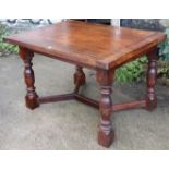 A rosewood dining table with a rectangular top, & on four bulbous-turned legs with diagonal