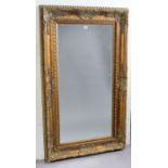 A large gilt frame rectangular wall mirror with a raised & foliate scroll border & inset with a