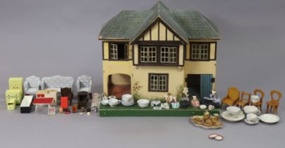A mid-20th century small wooden two-storey doll’s house with an opening front, 48cm wide x 40.5cm