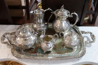 A silver plated four-piece tea & coffee service with embossed foliate design; two similar tea-trays;