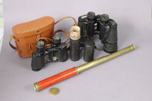 A vintage brass two-draw pocket telescope, 49cm long (open), cased; & two pair of field glasses (one