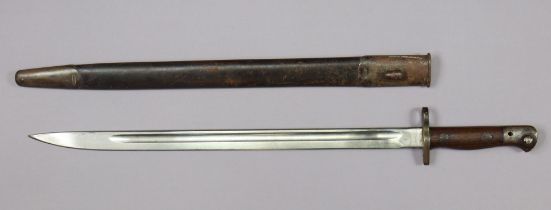 A 19th century British rifle bayonet with a hardwood grip stamped “R.E. 1819” having a 43.5cm long