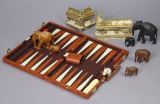 Six carved wooden elephant ornaments; a section of gilt moulding; & a modern backgammon set.