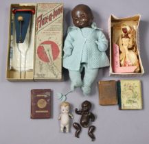 A mid-20th century Rosebud black baby doll, 38cm tall, dressed; together with three small dolls;