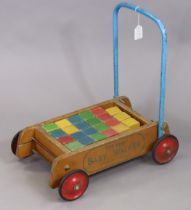 A 1960’s Tri-ang “baby walker” complete with coloured building blocks.