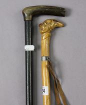 A mid-19th century walking cane with a novelty carved male head handle, & with a silver plated