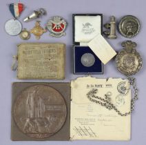 A WWI memorial death plaque “Elmer Winfrid Drake Laing”; a WWI “First Field Dressing”; a silver