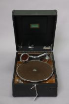 A vintage Electrola portable gramophone in a black fibre-covered case.