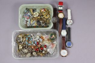 A collection of badges & tunic buttons; seven wristwatches; & various items of costume jewellery.