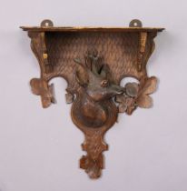 A vintage Black Forest wooden wall bracket with a carved stag’s head to centre (slight faults), 27cm