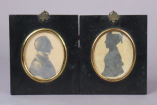 A pair of 19th century silhouette portraits of a lady & a gentleman, 8.5cm x 7cm, (oval), in