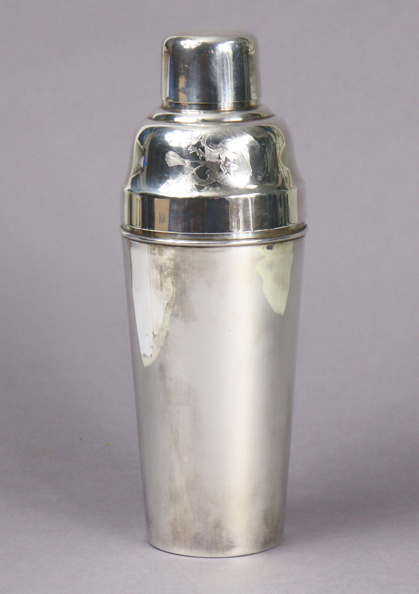 A 1930s Mappin & Webb “Prince’s Plate” cocktail shaker with engraved decoration, 24.5cm high.