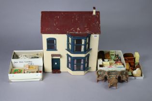 A mid-20th century painted wooden two-storey doll’s-house with an opening back, 50.5cm wide x 57cm