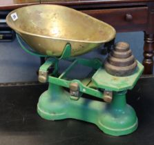 A set of vintage green painted cast-iron counter-top scales with a brass pan & four iron weights.