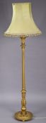 A giltwood standard lamp having a fluted & turned centre column, & on a circular base with bun feet,