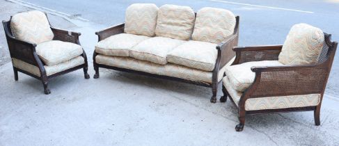 A 19th century continental-style beech frame three-piece lounge suite comprising a three-seater