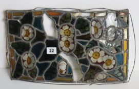 A leaded stained glass window panel, 23.5cm x 39cm (w.a.f); a pair of cream metal wall appliques;