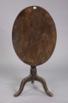 A 19th century mahogany tripod table with an oval tilt-top, & on a vase-turned centre column & three