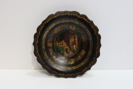 A Victorian black laqcuer papier-mâche dish with painted scene of Napoleon to the centre, 25cm dia.;